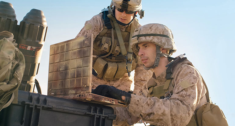 Soldiers are Using Laptop Computer for Surveillance During Military Operation in the Desert.